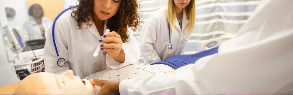 Nursing Students in Sim Lab with manikin